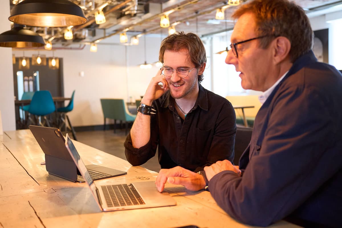 A mentor and startup founder reviewing work together at Akcela in Norwich